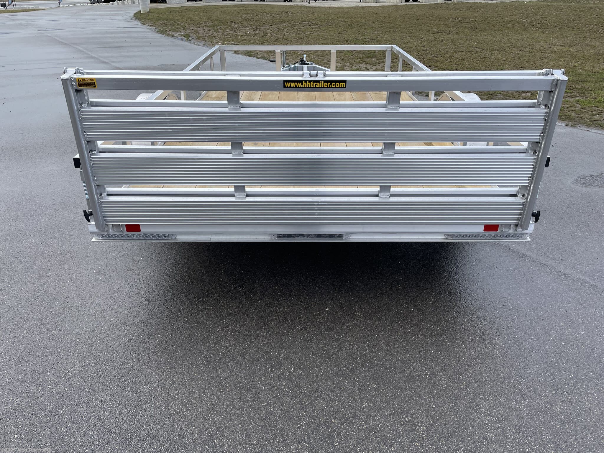 Utility Trailer H & H 7 X 14 Aluminum Rail Side, 3 X 2 Angle Aluminum Extrusion Frame, Aluminum Extrusion Tube Upright Sides, 2 x 2 Tube Top Rail, Aluminum Triple Tube Tongue, Treated Wood Deck, 15" Aluminum Wheels, 15" Radial Tires, A-Frame Posi-lock Coupler, Dual Safety Chains & Hooks, Swivel Jack with Caster Wheel, LED Lighting, Sealed Wiring Harness, Aluminum Stake Pockets, 54" Bi-Fold Gate, Brakes: None, Load Angle & Ramp Length, Load Angle: 17°, Ramp Length: 58", Ramp Pivot Point Measurements, Aluminum Trailer Accessories, Heavy Duty Aluminum Trailer, Aluminum Extrusion Components, Trailer Parts and Accessories, Custom Aluminum Trailer Features, Durable Aluminum Trailer, LED Trailer Lighting, Swivel Jack Trailer Equipment, Safety Chains and Hooks, Aluminum Stake Pocket Design, Treated Wood Decking for Trailers, 15" Radial Trailer Tires, A-Frame Coupler Trailer, Bi-Fold Gate Trailer, High-Quality Aluminum Wheels, Ramp Length Specifications, Trailer Load Angle, Aluminum Extrusion T