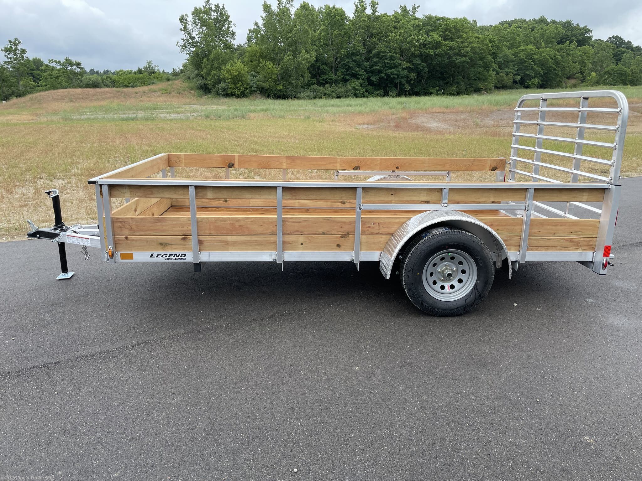 Legend High Side Legend Aluminum 3-Board Utility Trailer, 16" Deck Height, 48" Ramp Gate, 3k EZ-Lube Axle, ST20575R14 Silver Mod Steel Tires, 3" Cross Member, 24" On Center Cross Member, 3" Angle Frame, Treated Wood Decking, LED Lighting, 2" A-Frame Coupler, 2k Top-Wind Jack, ATP Fenders, Load Angle & Ramp Length, Load Angle: 16°, Ramp Length: 48", Measured from Ramp Pivot Point, Utility Trailer with Aluminum Frame, Heavy-Duty Utility Trailer, Aluminum Utility Trailer Features, EZ-Lube Axle Trailer, Steel Tires for Utility Trailers, Cross Member Spacing, Angle Frame Trailer Design, Treated Wood Decking for Trailers, LED Lights for Trailers, A-Frame Coupler Specifications, Top-Wind Jack for Trailers, ATP Fenders for Utility Trailers, Load Angle Specifications, Ramp Length Specifications, Trailer Deck Height, Utility Trailer Ramp Gate, Aluminum Utility Trailer Specifications, Utility Trailer Components, Utility Trailer with LED Lighting, Heavy-Duty Ramp Gate, Utility Trailer Axle, Traile