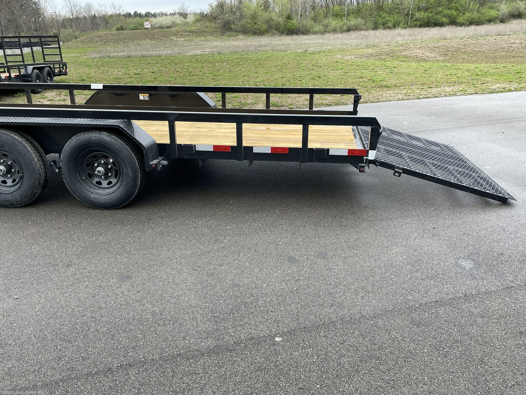 H&H 82" x 22' Heavy Duty Landscape/Utility Trailer, 5" x 3" x 1/4" Steel Angle Frame, 3" x 2" x 3/16" Steel Angle Crossmembers, 5" Steel Channel Tongue, Fully Wrapped, 3" x 2" Steel Tube Top Rail, 2-5/16" A-Frame Posi-Lock Coupler, Dual Safety Chains and Hooks, 7-Way RV-Style Plug, Enclosed Sealed Wiring Harness, 7k Rated Setback Drop Leg Jack, 50" Tall Reinforced Spring Assist Gate, Ladder Style Gate, Steel Formed Tread Plate Fenders, Tandem Spring Brake Suspension, 9900 lb GVWR, Easy Lube Hubs, ST225/75R15 'D' Tires, 15" Black Steel Wheels, Industrial Grade Polymer Finish, 2 x 8 Pressure Treated Pine Decking, Welded Front Board Retainer, Rear End Board Cap, Stake Pockets, Spare Tire Mount, Full LED DOT Compliant Lighting, Heavy Duty Utility Trailer, Landscape Trailer, Steel Angle Frame Trailer, Heavy Duty Trailer, Landscape Utility Trailer, Tandem Axle Utility Trailer, Spring Assist Gate Trailer, Steel Channel Tongue Trailer, Pressure Treated Pine Deck Trailer, Black Steel Wheels Tra