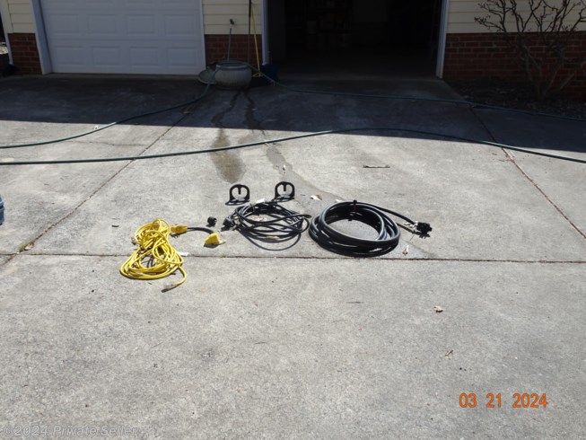 three electrical cords -50.30,15 amp with adapters, surge protector, all sewer pipes, honey wagon, chalks, plexiglass window for screen door, tripod for stabilizing front hitch when camper is set up