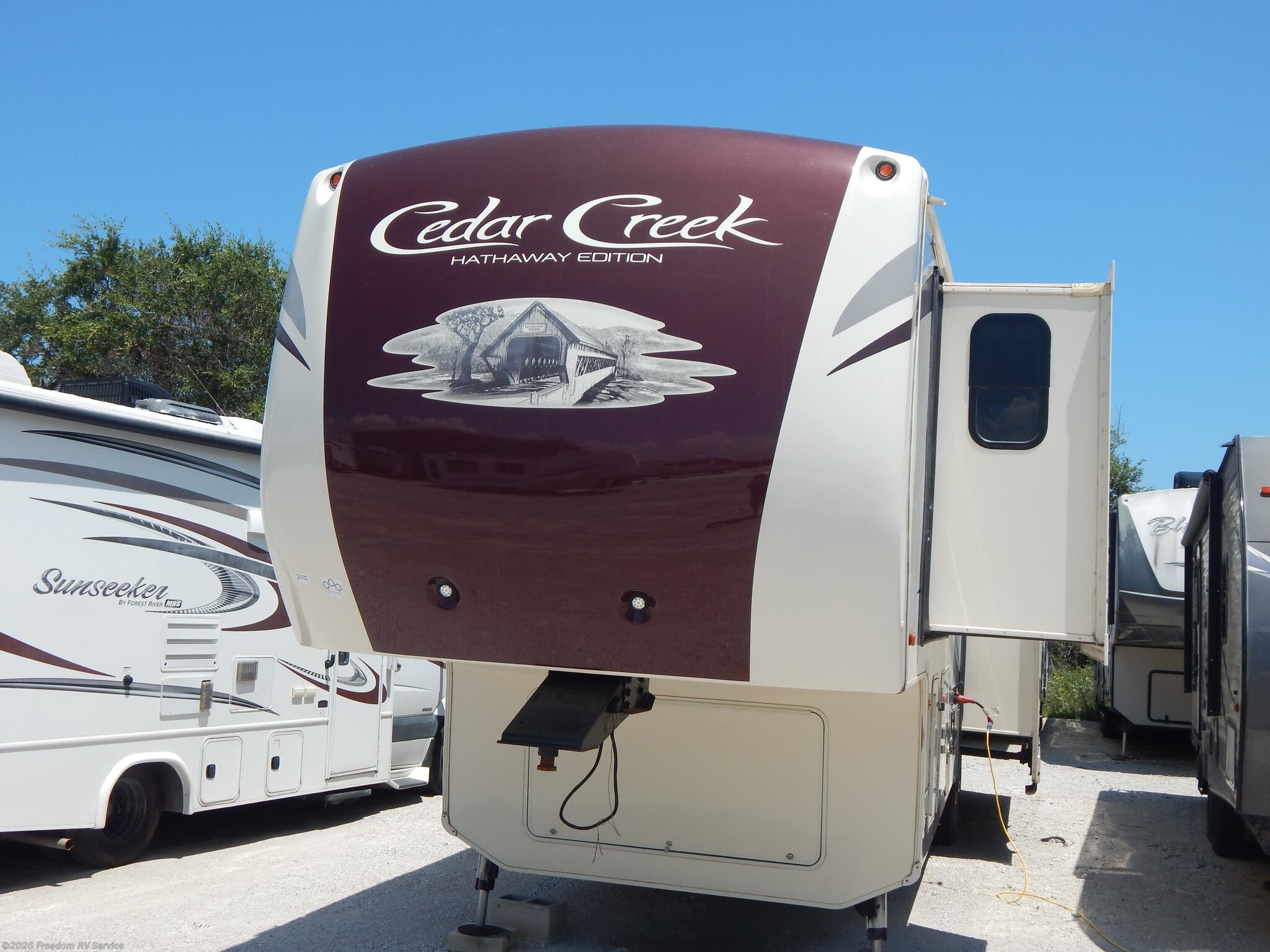 2017 Forest River Cedar Creek 36CK2 - Used Fifth Wheel For Sale by Freedom RV Service in Aransas Pass, Texas features Ladder, Leveling Jacks, Power Roof Vent, Free Standing Dinette w/Chairs, Exterior Speakers