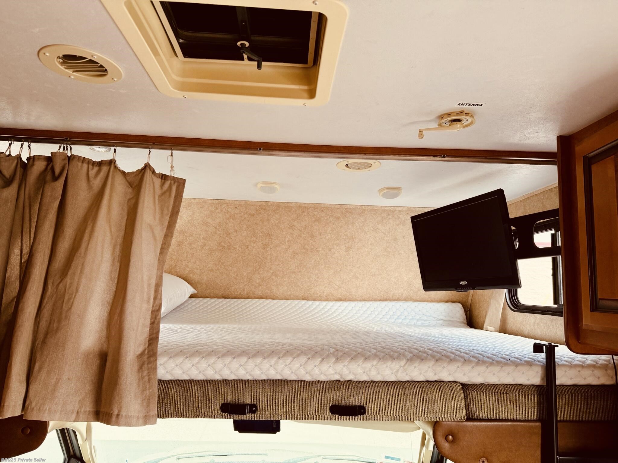 Queen bed with memory foam mattress topper above cab with TV!