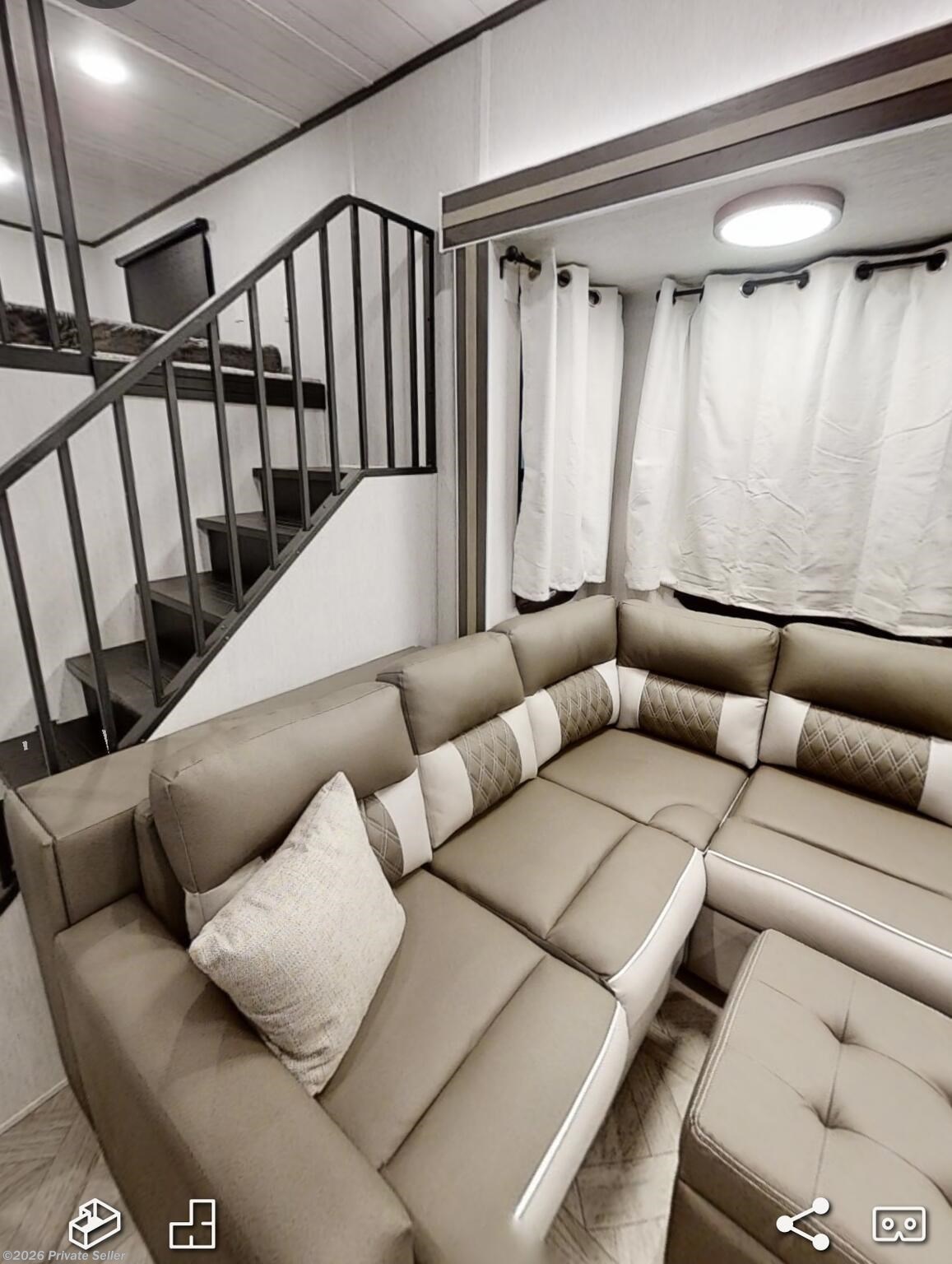 Living room view. Couch has a pull out bed. And storage behind and under couch 