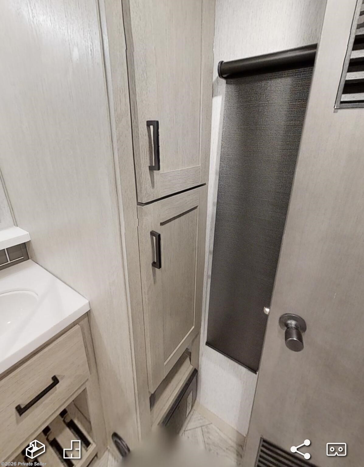 Bath storage view and door opens to washer and storage. 