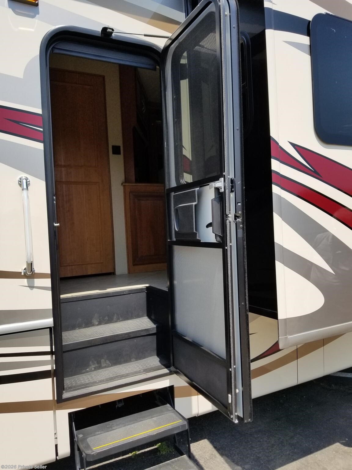 Mid coach entrance w/ electric entry step and lighted handrail and LED porch lighting