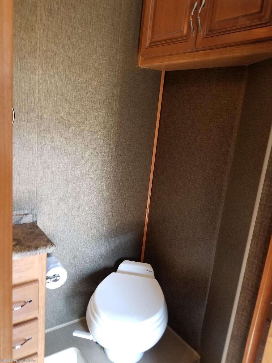 Residential Porcelain toilets w/vac flush.  Overhead storage cabinets