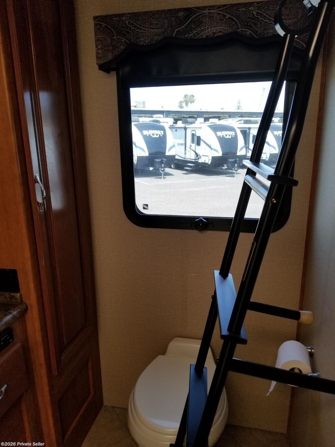 Master bath w/ residential porcelain toilet.  Ladder is for front cabover bed.