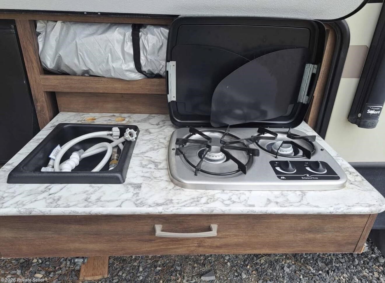 Outdoor kitchen with mini-fridge, sink, and propane cooktop